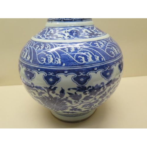 319 - An antique Chinese blue and white vase with old staple repairs to the neck - Height 40cm