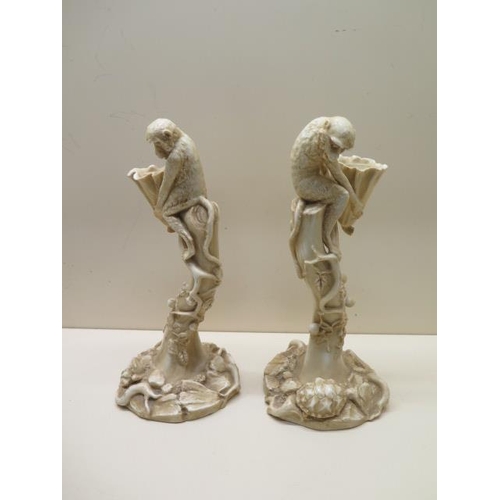 326 - A pair of Royal Worcester ivory blush monkey candlesticks - Height 27cm - numbered 1140 - both good ... 