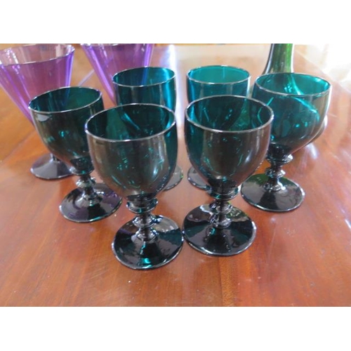 336 - Six green glass goblets - Height 13cm - a green glass decanter with silver cross cork and a pair of ... 