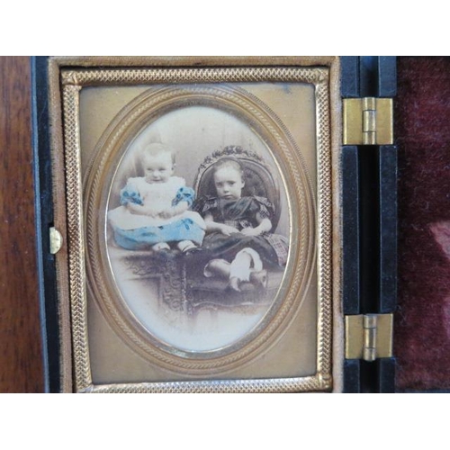 337 - A Victorian coloured photograph of two children in an ornate case - 7.5cm x 6.5cm - good condition