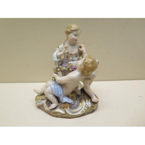 355 - A Meissen group boy Cupid and a young girl - Height 12cm - some foliate chipping to garland otherwis... 