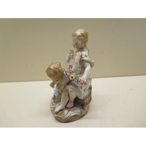 355 - A Meissen group boy Cupid and a young girl - Height 12cm - some foliate chipping to garland otherwis... 