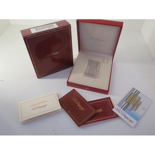 388 - A silver Dupont lighter with box and paperwork - in good condition, engraved to cartouche