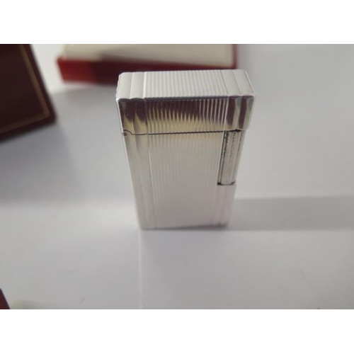 388 - A silver Dupont lighter with box and paperwork - in good condition, engraved to cartouche