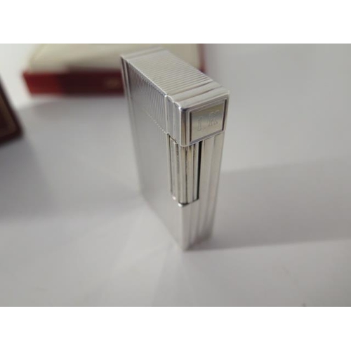 388 - A silver Dupont lighter with box and paperwork - in good condition, engraved to cartouche