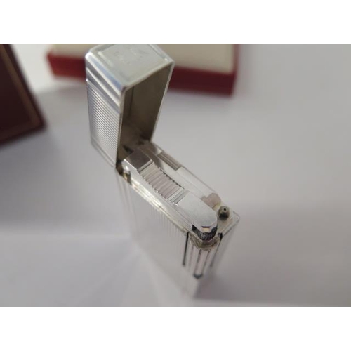 388 - A silver Dupont lighter with box and paperwork - in good condition, engraved to cartouche