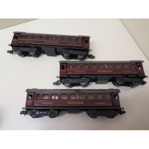 407 - Three early tinplate Marklin OO gauge coaches, two 0-4-4 locos (make unknown) and nine wood and meta... 