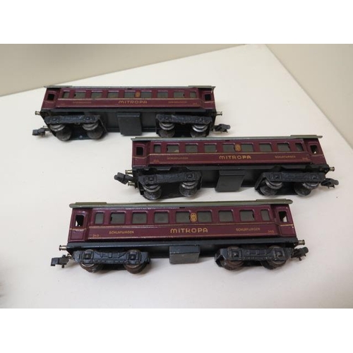 407 - Three early tinplate Marklin OO gauge coaches, two 0-4-4 locos (make unknown) and nine wood and meta... 