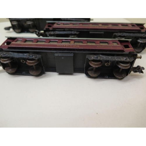 407 - Three early tinplate Marklin OO gauge coaches, two 0-4-4 locos (make unknown) and nine wood and meta... 