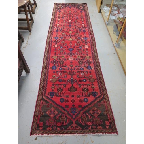 506 - A handmade Persian runner - in good condition - 290cm x 83cm