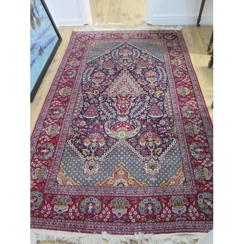 508 - A fine Persian rug with a red field - 220cm x 135cm - in good condition