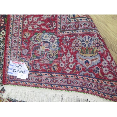 508 - A fine Persian rug with a red field - 220cm x 135cm - in good condition