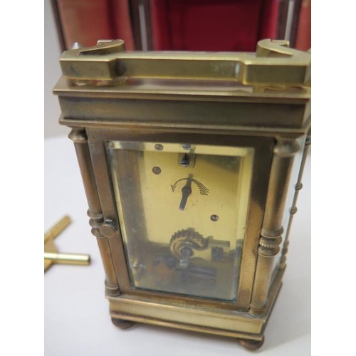 533 - A brass hexagonal carriage clock - Height 12cm with handle down in original case with a spider key -... 