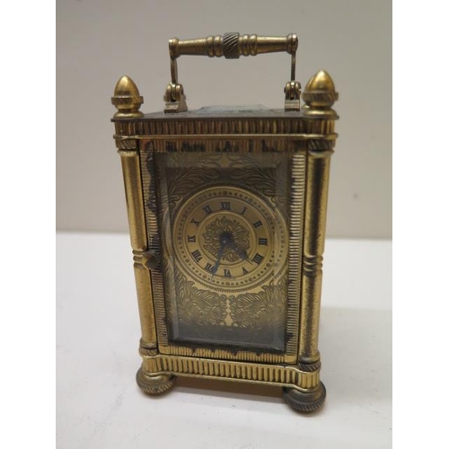 534 - A good quality miniature carriage clock in a brass engraved case and dial - in working order - 10cm ... 