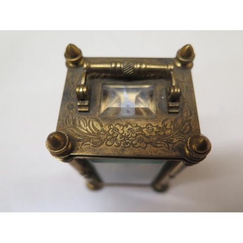 534 - A good quality miniature carriage clock in a brass engraved case and dial - in working order - 10cm ... 