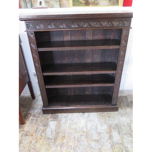 540 - A 1930's oak bookcase with a carved front - Width 91cm x Height 107cm x Depth 28cm