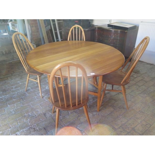 542 - An Ercol drop leaf dining table 140cm x 127cm - with four matching chairs