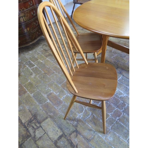 542 - An Ercol drop leaf dining table 140cm x 127cm - with four matching chairs