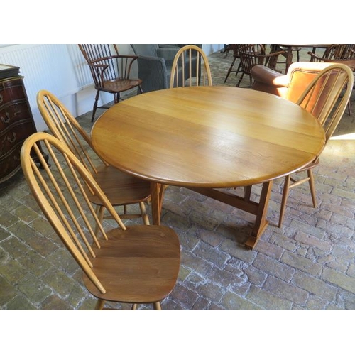 542 - An Ercol drop leaf dining table 140cm x 127cm - with four matching chairs