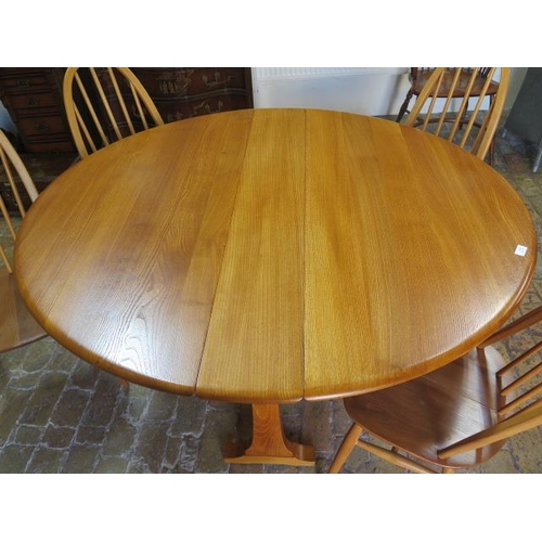 542 - An Ercol drop leaf dining table 140cm x 127cm - with four matching chairs