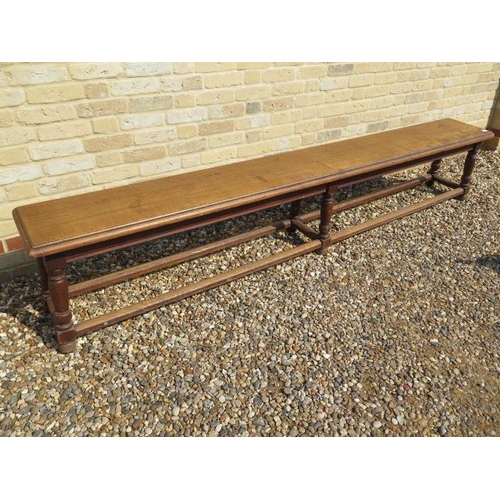 545 - A late 19th/20th century oak college bench on six turned legs - Length 256cm x Height 49cm