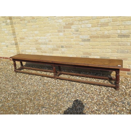 545 - A late 19th/20th century oak college bench on six turned legs - Length 256cm x Height 49cm