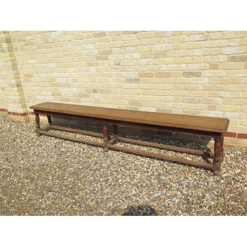 546 - A late 19th/20th century oak college bench on six turned legs - Length 256cm x Height 49cm