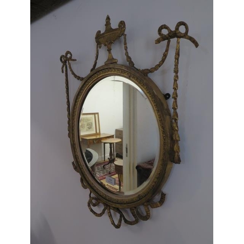 556 - A 19th century gilt circular mirror - 60cm x 45cm