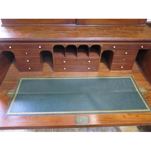 560 - A 19th century mahogany secretaire bookcase with a two door top having adjustable shelves above a fi... 