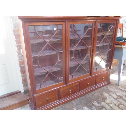 561 - A mahogany three door astragal glazed bookcase with four base drawers - Height 141cm x 178cm x 32cm