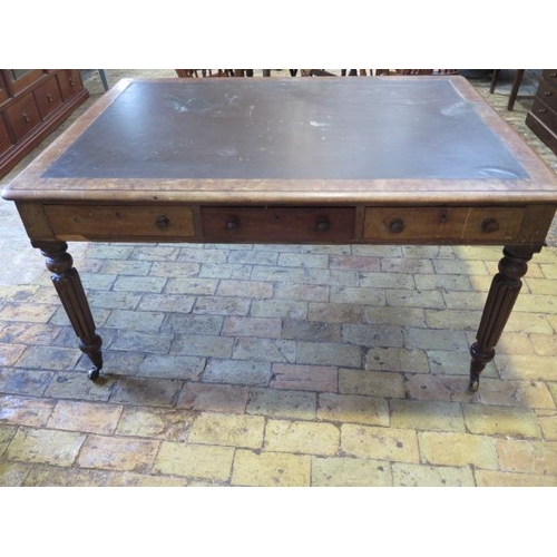 587 - A 19th century mahogany six drawer writing table on turned and reeded legs and brass caps and caster... 