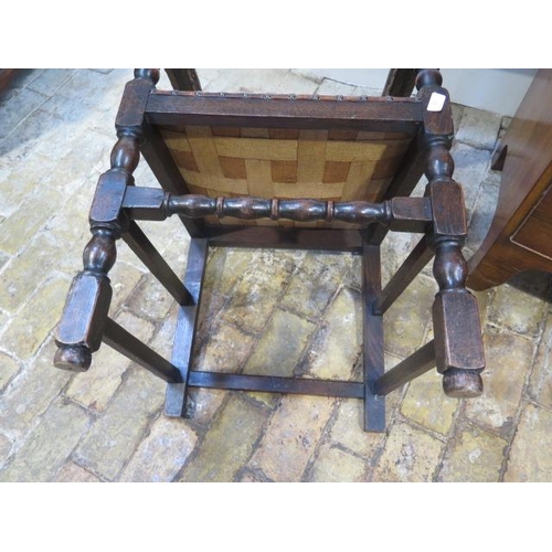 592 - A 17th/18th century oak armchair with a worn leather seat back and arms - sound condition and a nice... 