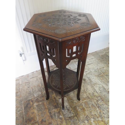 601 - A circa 1900's carved mahogany hexagonal two tier lamp table with fretwork frieze in the Morrish sty... 