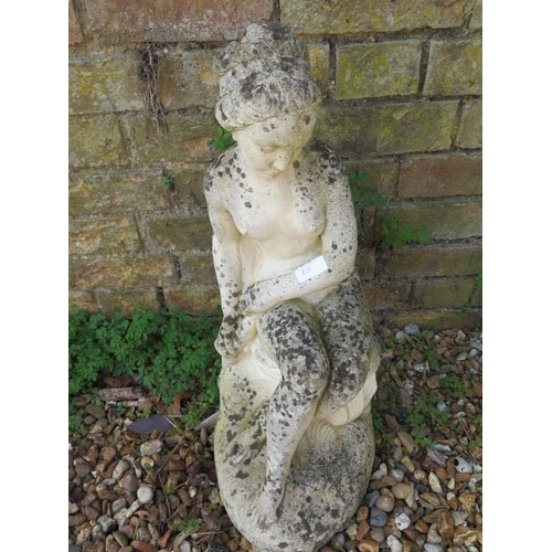 631 - A garden statue of a seated lady - Height 60cm