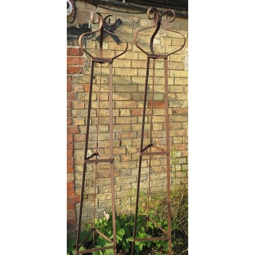 642A - A pair of hand forged wrought iron triangular section garden obelisks with scroll finials - Width 39... 