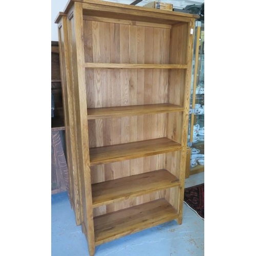 648 - A good quality oak four tier bookcase in very good condition - Height 195cm x Width 95cm