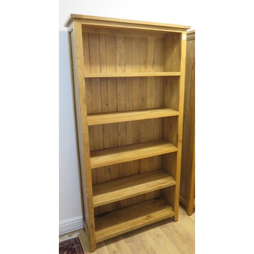 649 - A good quality oak four tier bookcase in very good condition - Height 195cm x Width 95cm