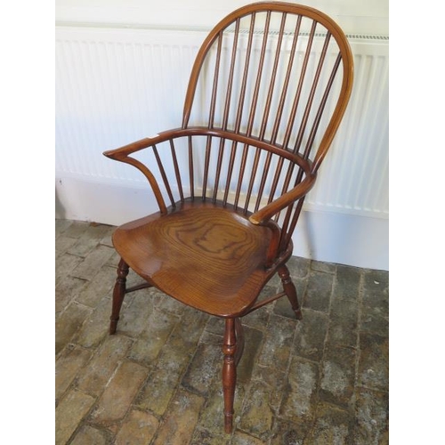 650 - An antique style Windsor armchair with a crinoline stretcher in very good condition