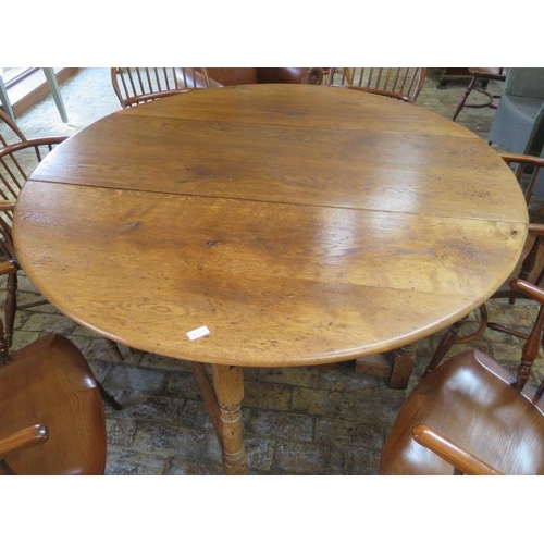 653 - A good quality oak or yewwood oval gateleg dining table with six Windsor armchairs with crinoline st... 