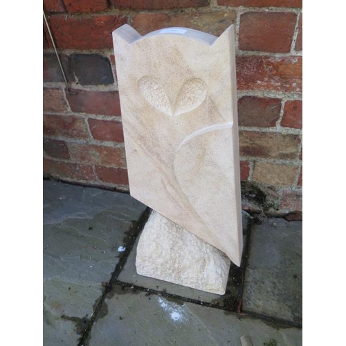 654 - A hand carved stylised owl made from natural limestone - 23cm x 54cm tall