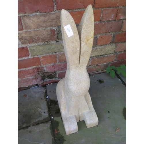 657 - A hand carved limestone hare - 9.5cm x 31cm x 61cm tall