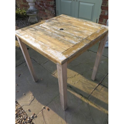 662 - A hardwood weathered garden table - 70cm square