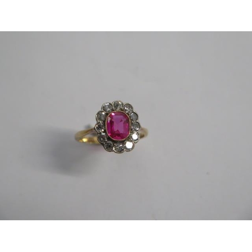 70 - An early 20th century ruby type stone and diamond cluster ring consisting of a centrally mounted cus... 