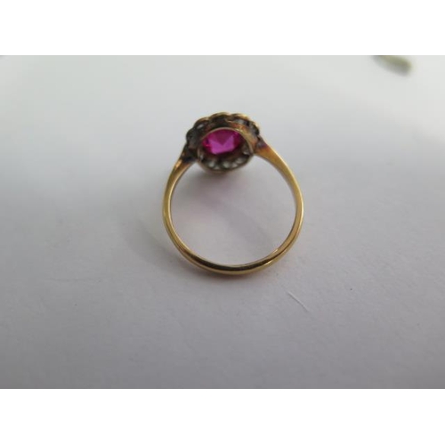 70 - An early 20th century ruby type stone and diamond cluster ring consisting of a centrally mounted cus... 