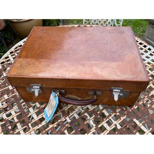 152A - An Antique tan leather Drew & Sons of Piccadilly traveling suitcase with dark green leather interior... 