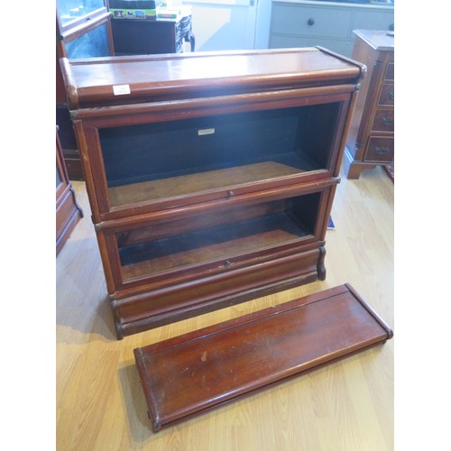 600 - A mahogany two section glazed Globe Wernicke stacking bookcase one with label, both glass panels mis... 