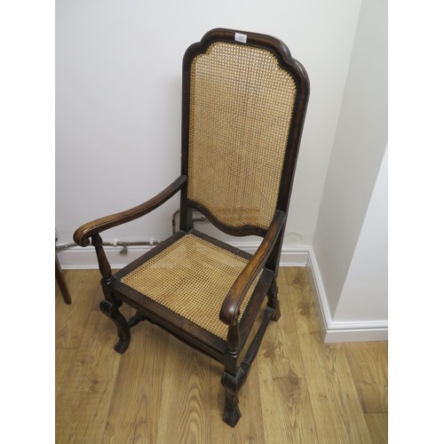 549 - A walnut armchair with a cane seat and back