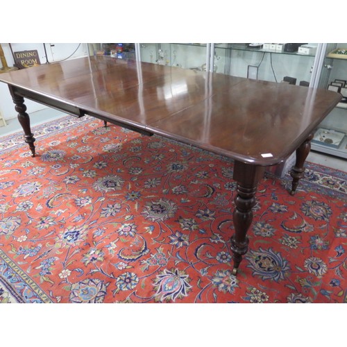 562 - A 19th century mahogany dining table with two leaves on turned legs - 240cm x 112cm extended, reduci... 