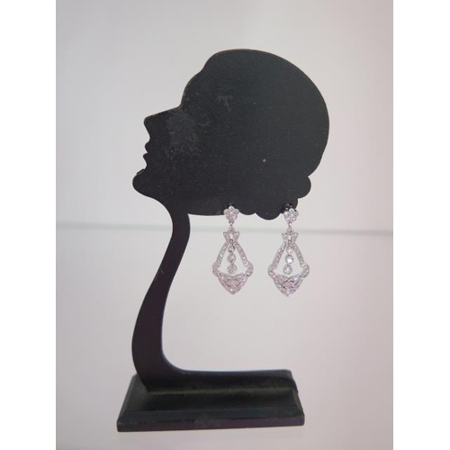 128 - A pair of 18ct white gold diamond drop earrings - approx 31mm x 14mm - diamonds bright and lively