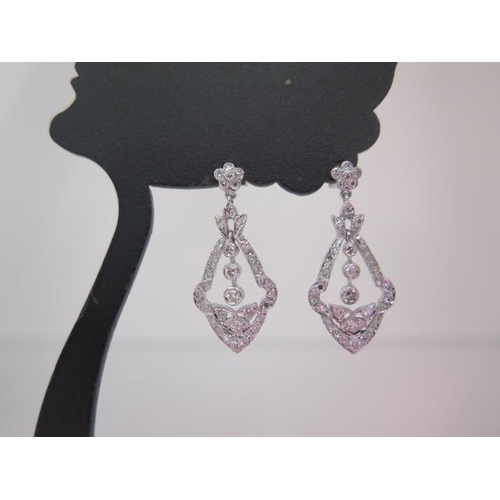 128 - A pair of 18ct white gold diamond drop earrings - approx 31mm x 14mm - diamonds bright and lively